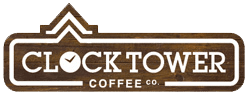 The Clocktower co logo in white and brown with a fake wood pattern.